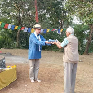 Dh. Chandrashil offering Blue Shirt