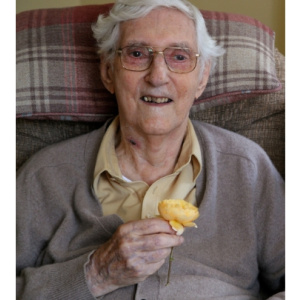 Sangharakshita holding a flower