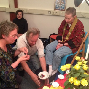 making a mala as a symbol of support from the sangha
